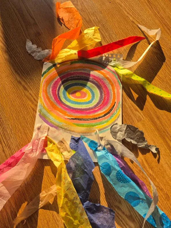 A colourful ribbon circle craft made with layered looping forms